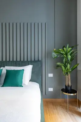a bedroom with a bed with a plant on a table at Angela luxury home,Premium Apartment for families in Rome