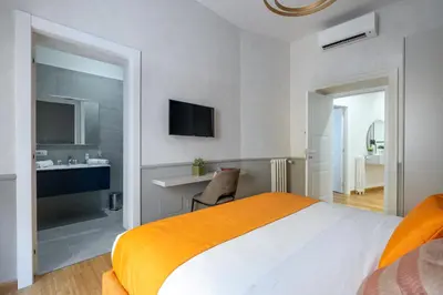 a bedroom with a bed and a bathroom with a sink at Angela luxury home,Premium Apartment for families in Rome