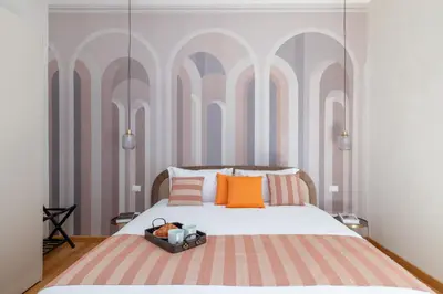 a bedroom with a bed with orange and pink pillows at Angela luxury home,Premium Apartment for families in Rome