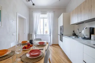 a kitchen with a table with plates of food on it at Angela luxury home,Premium Apartment for families in Rome