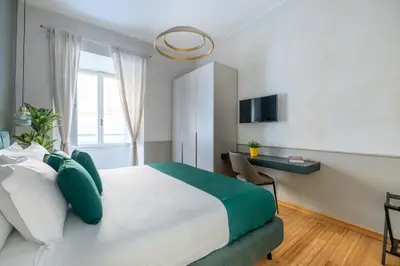 a bedroom with a large bed and a desk at Angela luxury home,Premium Apartment for families in Rome