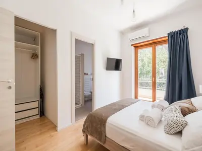 a bedroom with a large bed and a window at The Best Rent - Spacious flat a stone's throw from the Vatican in Rome