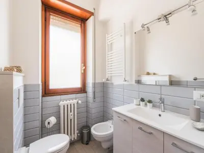 a bathroom with a sink toilet and a window at The Best Rent - Spacious flat a stone's throw from the Vatican in Rome