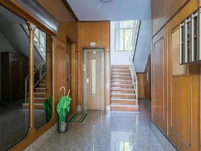 a hallway with stairs and a vase with an umbrella at The Best Rent - Spacious flat a stone's throw from the Vatican in Rome