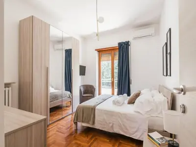 a bedroom with a bed and a mirror at The Best Rent - Spacious flat a stone's throw from the Vatican in Rome