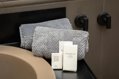two towels sitting on a table next to a bed at Amazing Piazza di Spagna in Rome
