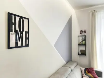 a living room with a couch and a picture on the wall at Attico Urbano Terrazza su Roma Metro A Cornelia in Rome