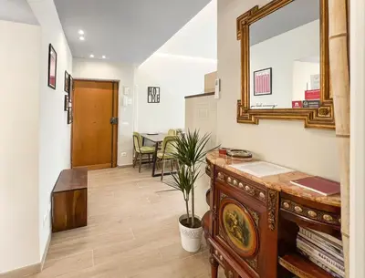 a hallway with a mirror and a table at Attico Urbano Terrazza su Roma Metro A Cornelia in Rome
