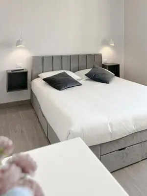 a bedroom with two beds and a tv at Attico Urbano Terrazza su Roma Metro A Cornelia in Rome