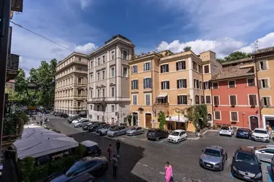 a city street with cars parked in a parking lot at Trastevere at Piazza Giuditta Arcuati suite in Rome
