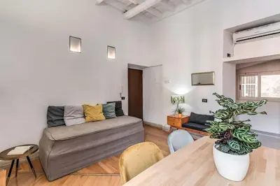 a living room with a couch and a table at Trastevere at Piazza Giuditta Arcuati suite in Rome