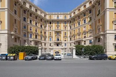 a large building with cars parked in front of it at Adriana Star luxury large and central in Rome