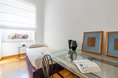 a bedroom with a glass table and a bed at Adriana Star luxury large and central in Rome