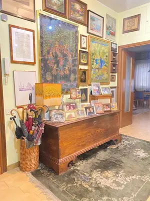 a room with a desk and many pictures on the wall at Room near San Pietro and Vaticano in Rome