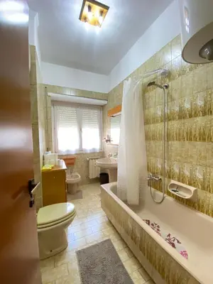 a bathroom with a toilet and a tub and a sink at Room near San Pietro and Vaticano in Rome