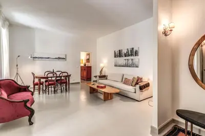 a living room with a couch and a table at Via Provana San Giovanni 2 bedroom apartment in Rome