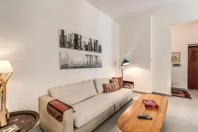a living room with a couch and a coffee table at Via Provana San Giovanni 2 bedroom apartment in Rome