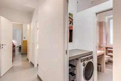 a white laundry room with a washer and dryer at Via Provana San Giovanni 2 bedroom apartment in Rome