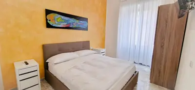 a bedroom with a bed and a painting on the wall at Rome Aparts - Deluxe Apartment with 3 bedrooms at St Peter square in Rome