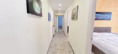 a hallway leading to a bedroom with a bed at Rome Aparts - Deluxe Apartment with 3 bedrooms at St Peter square in Rome