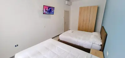 a small bedroom with two beds and a mirror at Rome Aparts - Deluxe Apartment with 3 bedrooms at St Peter square in Rome