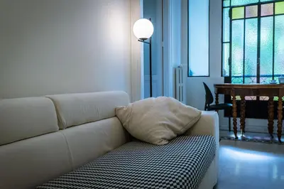 a white couch with a pillow on it in a living room at Trastevere 40 in Rome