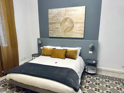 a bedroom with a bed with a blue wall at Trastevere 40 in Rome