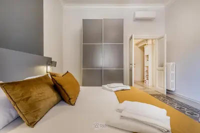 a bedroom with a large bed with two pillows at Trastevere 40 in Rome