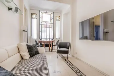 a living room with a white couch and a table at Trastevere 40 in Rome