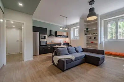 a living room with a couch and a kitchen at Glorioso Apartment Trastevere in Rome