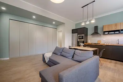 a living room with a couch and a kitchen at Glorioso Apartment Trastevere in Rome