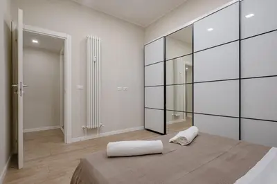 a bedroom with a bed and a glass wall at Glorioso Apartment Trastevere in Rome