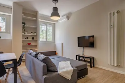 a living room with a couch and a tv at Glorioso Apartment Trastevere in Rome