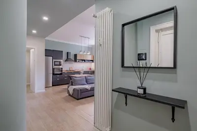 a living room with a mirror and a couch at Glorioso Apartment Trastevere in Rome