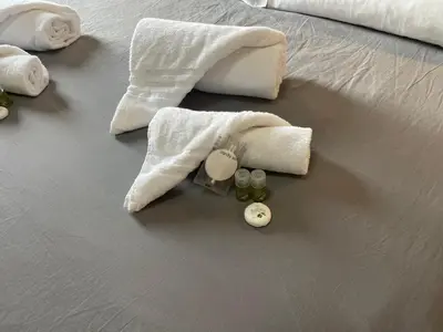 a group of towels and cosmetics on a bed at La Villa di Roma in Rome