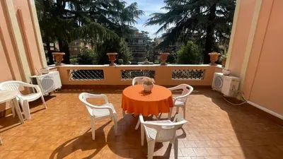 a patio with a table and chairs on a balcony at La Villa di Roma in Rome