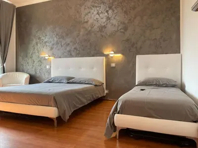two beds sitting next to each other in a bedroom at La Villa di Roma in Rome