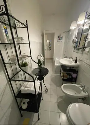 a bathroom with two sinks and a toilet at Colosseum Lindarella Home in Rome