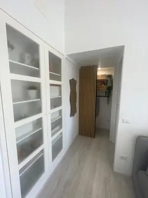 a room with white cabinets and a hallway at Colosseum Lindarella Home in Rome