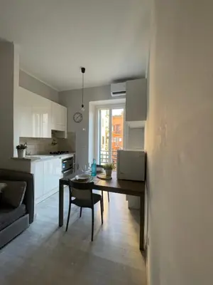 a kitchen with a table and a dining room at Colosseum Lindarella Home in Rome