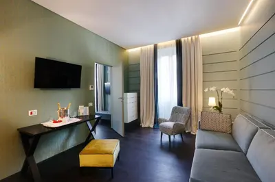a living room with a couch and a table at Stendhal Luxury Suites in Rome