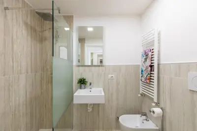 a bathroom with a sink and a mirror at iFlat Vatican Elegant and Spacious Apartment in Rome