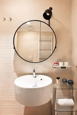 a bathroom with a white sink and a mirror at Idyllia - Maia luxury apartment in Rome