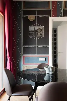 a dining room with a black table and chairs at Idyllia - Maia luxury apartment in Rome