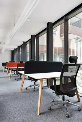 a row of desks in a room with windows at Idyllia - Maia luxury apartment in Rome