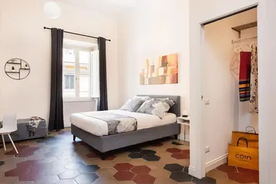 a bedroom with a bed and a large window at Idyllia - Vatican Stylish Flat in Rome
