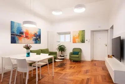 a dining room with a table and chairs at Idyllia - Vatican Stylish Flat in Rome