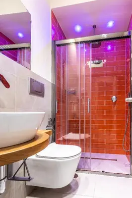 a bathroom with a shower and a toilet and a sink at Dafne room Nido perfetto per coppie a Roma in Rome