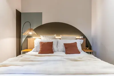 a bedroom with a large white bed with two pillows at Dafne room Nido perfetto per coppie a Roma in Rome