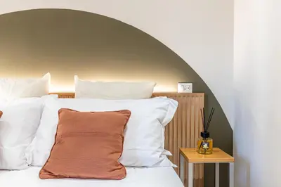 a bedroom with a bed with white pillows at Dafne room Nido perfetto per coppie a Roma in Rome